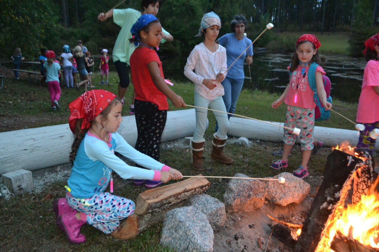 Daisy Girl Scouts gather around the campfire and roast marshmallows!
