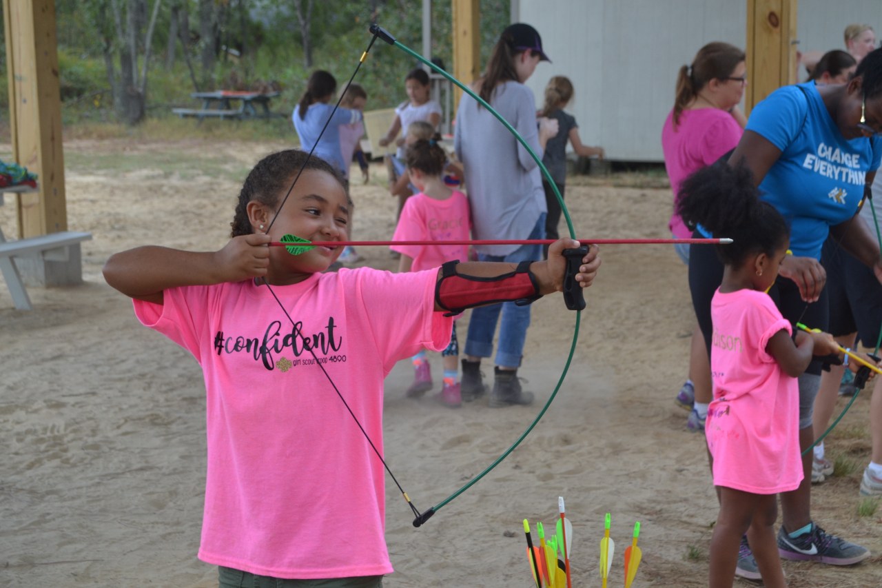 Daisy Girl Scout confidently tries her hand at archery.